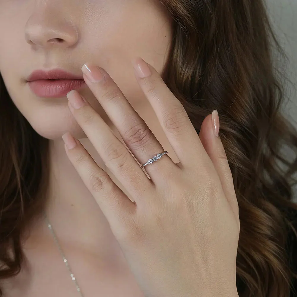CLASSIC ROUND MOISSANITE THREE-STONE BAND RING IN STERLING SILVER - Image 2